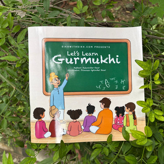 Book titled 'Let's Learn Gurmukhi' on a green leafy background